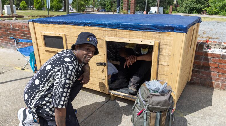 Brandon Brando with Reginald Driskell, a homeless man living in southwest Atlanta who he befriended and constructed a 7 by 3 foot wooden structure for the man with circulating air to get him out of an old cardboard box he's been living in. He'd like to do that for others as well. 
 PHIL SKINNER FOR THE ATLANTA JOURNAL-CONSTITUTION.