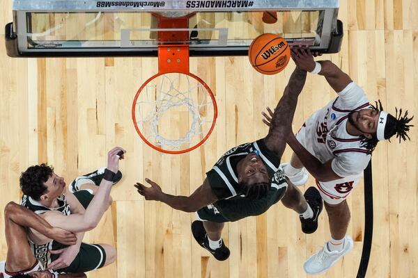 Auburn forward Chaney Johnson (31) shoots against Michigan State forward Coen Carr (55) during the second half in the Elite Eight of the NCAA college basketball tournament, Sunday, March 30, 2025, in Atlanta. (AP Photo/George Walker IV)