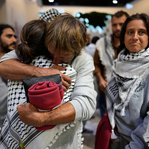 Activists from the Global Sumud Flotilla comfort each other upon their arrival at Istanbul Airport, in Istanbul, Turkey, Thursday, May 21, 2026. (AP Photo/Emrah Gurel)