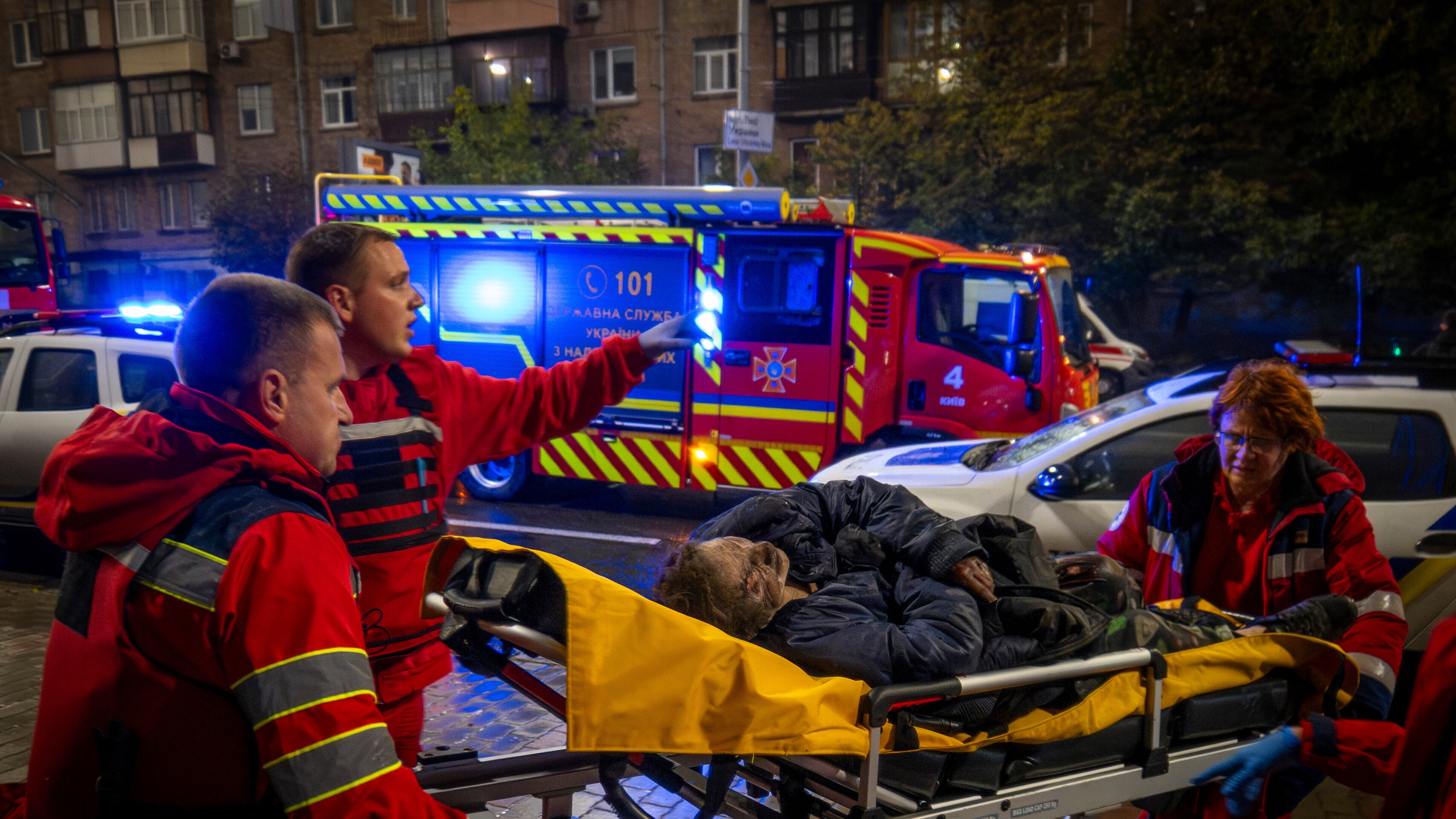 Paramedics evacuate an injured woman after a Russian strike on a residential building in Kyiv, Ukraine, Friday, Oct. 10, 2025. (AP Photo/Dan Bashakov)