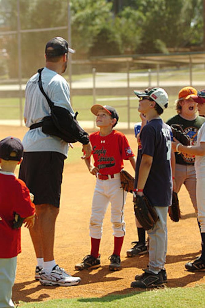 Smoltz coaches young fans at baseball camp