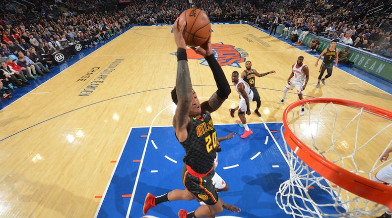 John Collins of the Atlanta Hawks dunks the ball against the New York Knicks on December 21, 2018 at Madison Square Garden in New York City, New York.