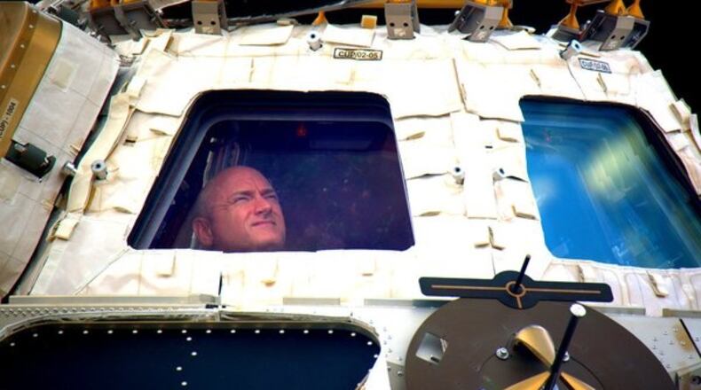 FILE - In this undated photo provided by NASA on Tuesday, March 1, 2016, astronaut Scott Kelly looks out the cupola of the International Space Station. (NASA via AP, File)