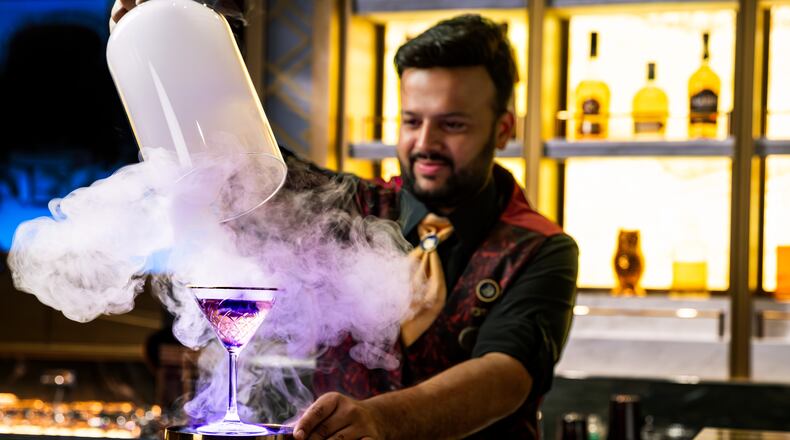 A bartender unveils a smoke-filled cocktail at Spellbound, where theatrical presentations are part of the immersive cocktail experience aboard the Star Princess. (Courtesy of Princess Cruises)