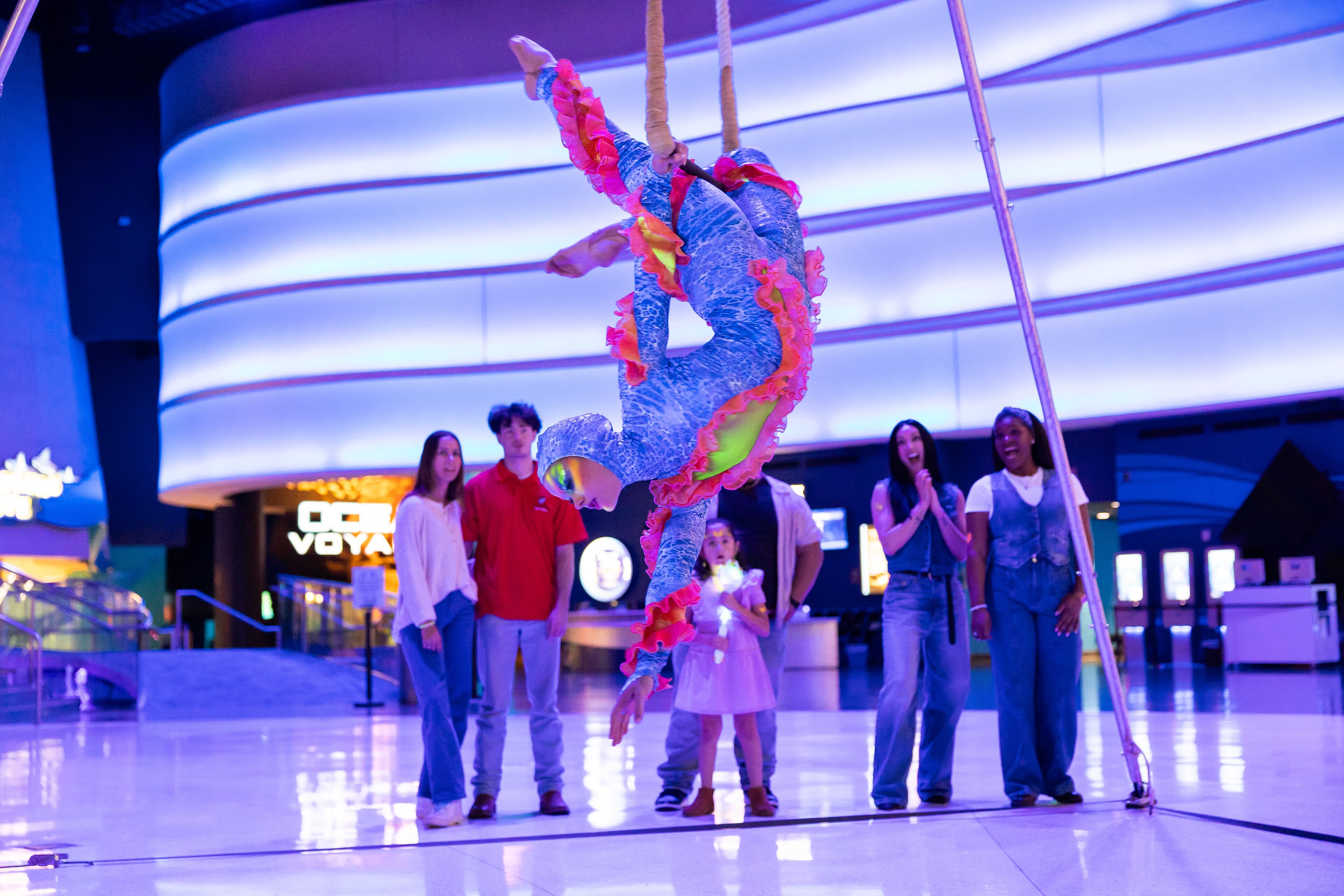 An aerial dancer performs during a dress rehearsal of Georgia Aquarium's Glow Nights, a new summer event that features jugglers, aerialists, sway pole artists and unicyclists. (Courtesy of Addison-Hill)