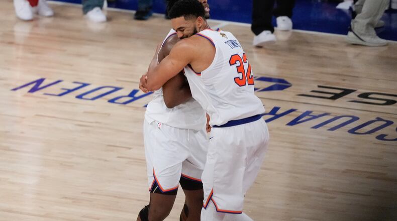 New York Knicks center Karl-Anthony Towns (32) embraces forward Og Anunoby after Game 4 of the NBA Finals basketball series against the San Antonio Spurs, Wednesday, June 10, 2026, in New York. (AP Photo/Ross D. Franklin)
