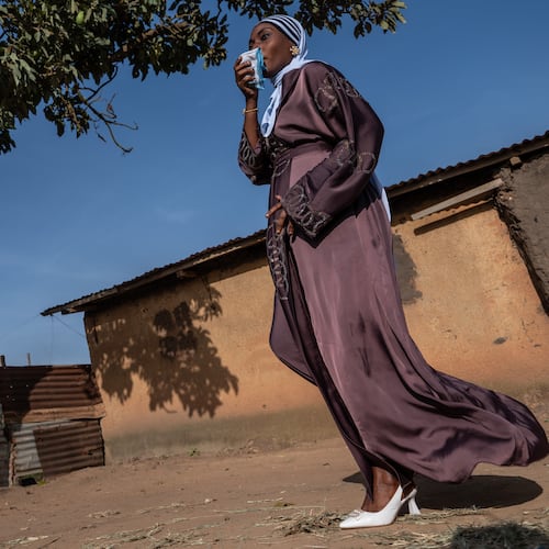 A Muslim woman walks towards the prayer grounds at Sayo Muhamed School to perform Eid al-Adha prayers amid an Ebola outbreak in Bunia, Congo, Wednesday, May 27, 2026. (AP Photo/Moses Sawasawa)