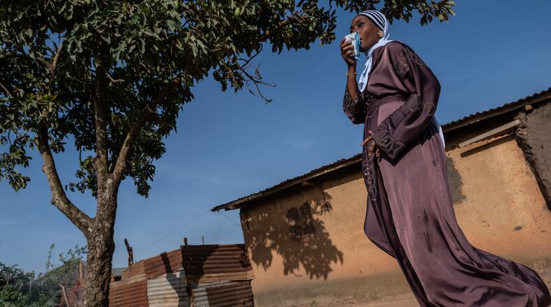 A Muslim woman walks towards the prayer grounds at Sayo Muhamed School to perform Eid al-Adha prayers amid an Ebola outbreak in Bunia, Congo, Wednesday, May 27, 2026. (AP Photo/Moses Sawasawa)