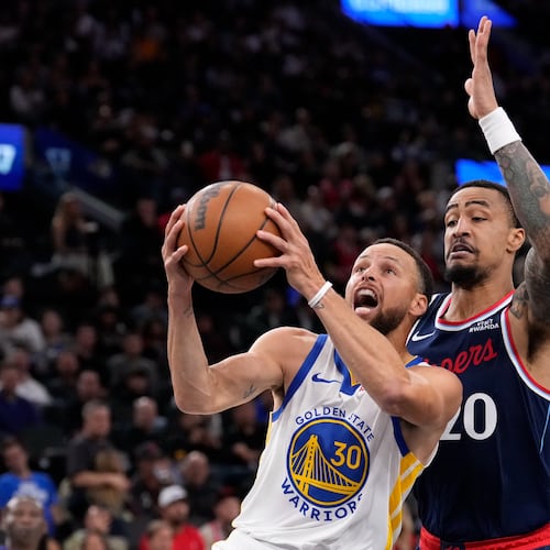 Golden State Warriors guard Stephen Curry, left, shoots as LA Clippers forward John Collins defends during the first half of an NBA play-in tournament basketball game Wednesday, April 15, 2026, in Inglewood, Calif. (AP Photo/Mark J. Terrill)