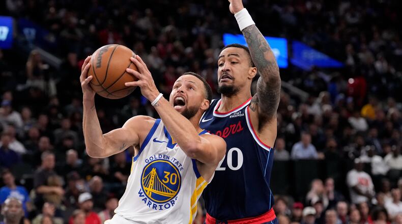 Golden State Warriors guard Stephen Curry, left, shoots as LA Clippers forward John Collins defends during the first half of an NBA play-in tournament basketball game Wednesday, April 15, 2026, in Inglewood, Calif. (AP Photo/Mark J. Terrill)