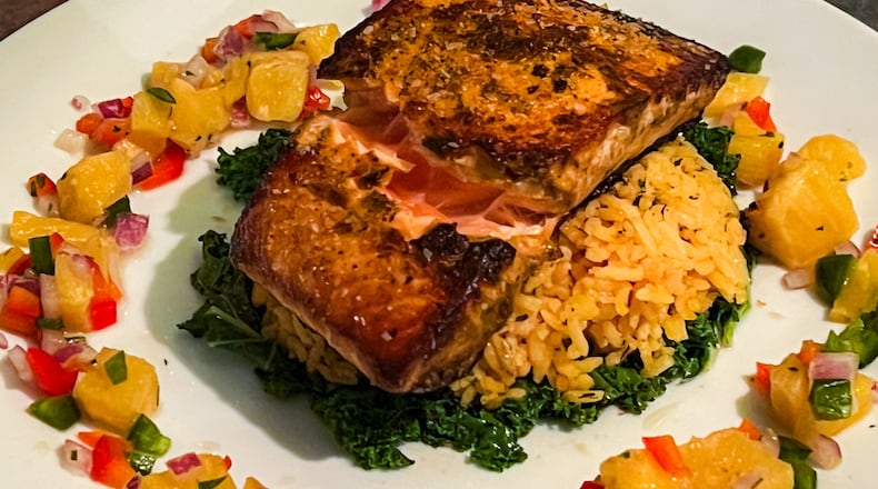 The adobo salmon at Natalie Bianca was cooked to near perfection, far exceeding expectations. (Henri Hollis/AJC)