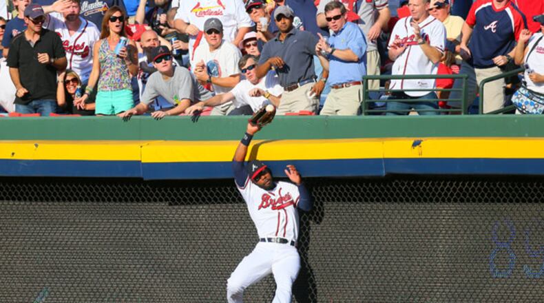 100512 ATLANTA: Atlanta Braves right fielder Jason Heyward (22) makes a leaping catch of St. Louis batter Yadier Molina's pop fly in the second inning of the National League wild card game at Turner Field in Atlanta on Friday, Oct. 5, 2012. CURTIS COMPTON / CCOMPTON@AJC.COM Heyward makes consistently strong throws and all the routine plays, and occasionally some spectacular ones, too.