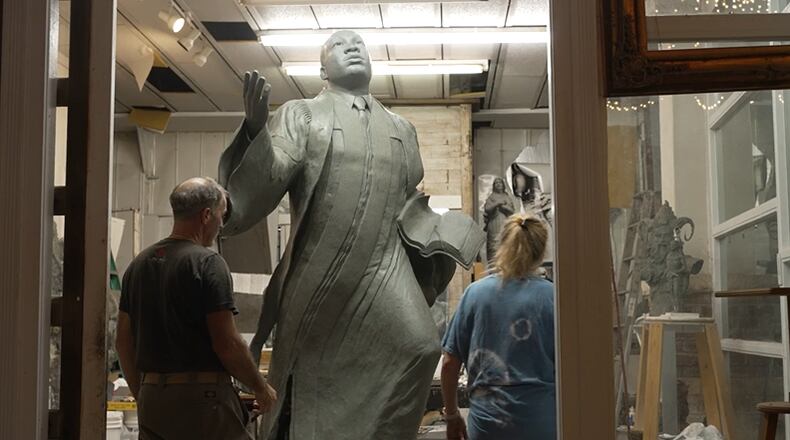 Sculptors Stan Mullins of Athens and Kathy Fincher of Duluth work on the new Martin Luther King, Jr. statue in Mullins' Athens studio. The statue, titled "I've Been to the Mountaintop," will will be installed at Rodney Cook Sr. Peace Park on Saturday. (World Peace Revival)