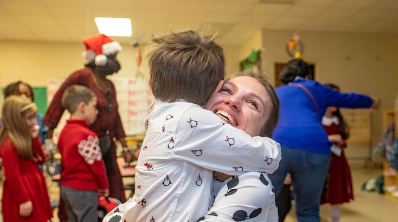 Oleksandra Slasna visits her 5-year-old son Yurii Slasnyi in his kindergarten classroom at Briar Vista Elementary School on Thursday, Dec 15, 2022 after watching him sing the school's holiday performance.  The Ukraine refugees are working to secure healthcare, housing and other basics.   Oleksandra gets emotional seeing her son in his classroom for the first time. (Jenni Girtman for The Atlanta Journal-Constitution)