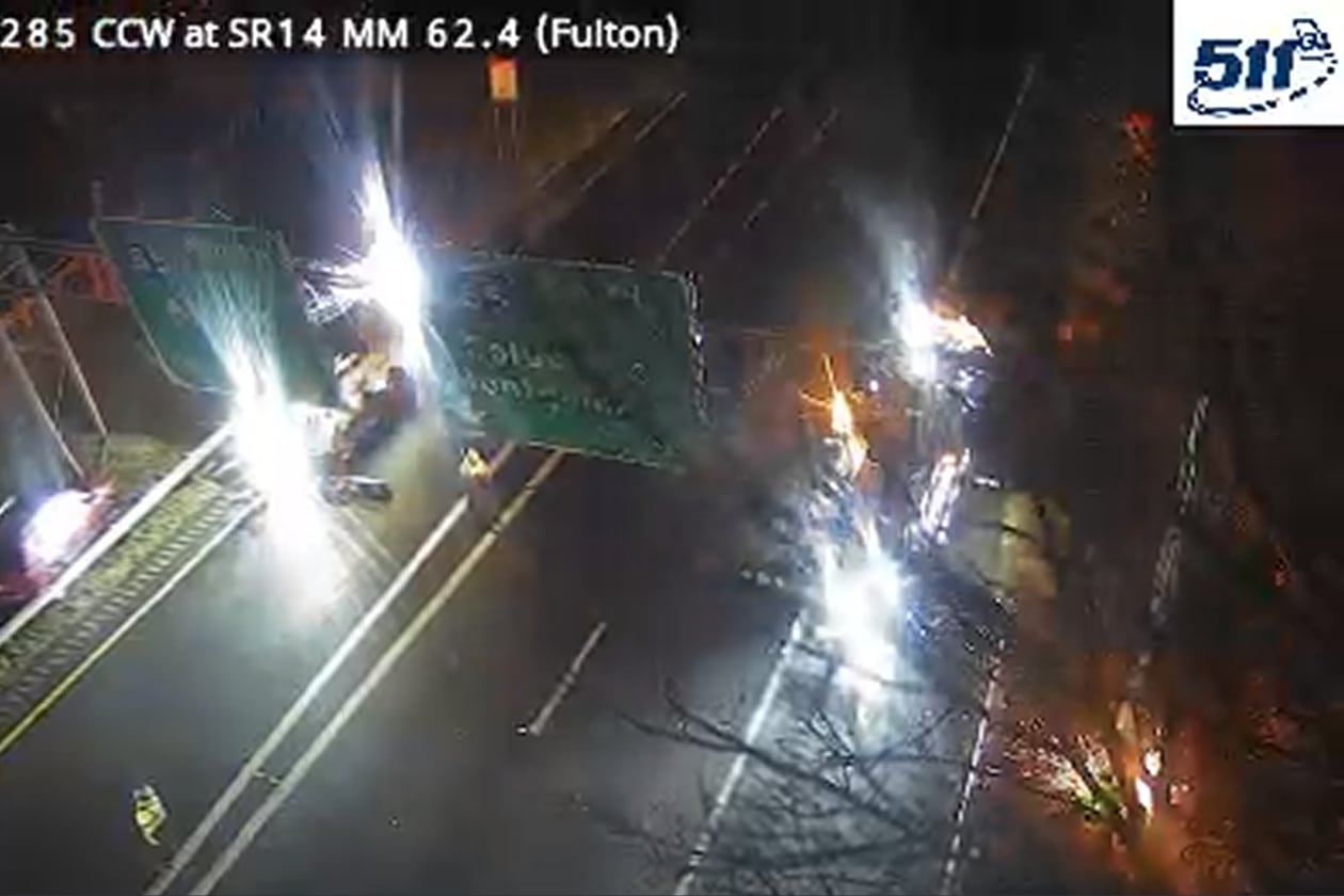 Georgia Department of Transportation workers bring down the sign over the I-285 South ramp to I-85 following a crash early Wednesday, Jan. 14, 2025.