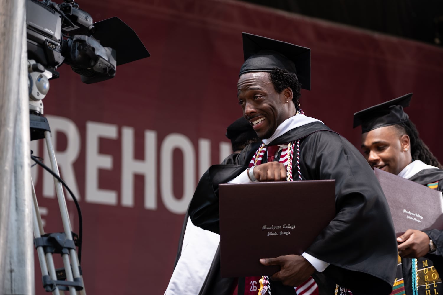 A student reacts after receiving his diploma at the Morehouse College graduation Sunday, May 17, 2026. (Ben Gray for the AJC)