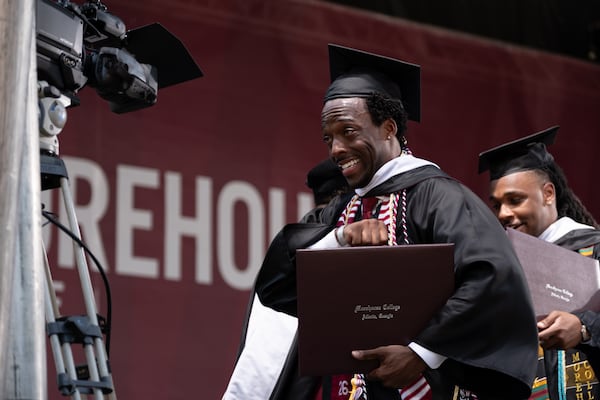 A student reacts after receiving his diploma at the Morehouse College graduation Sunday, May 17, 2026. (Ben Gray for the AJC)