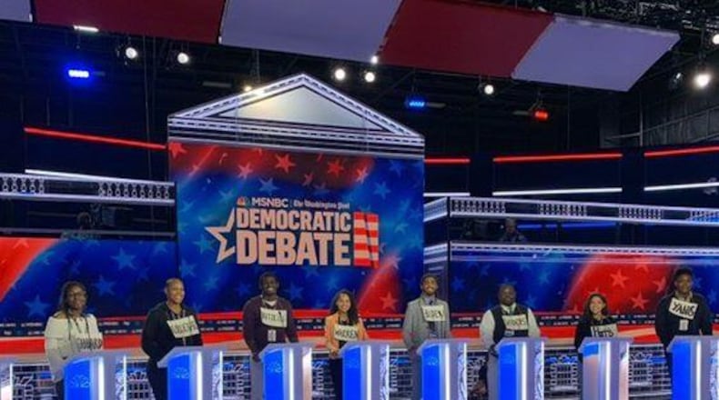 Georgia State University students stand behind the lecterns the Democratic Party presidential candidates used for their Wednesday night debate in Atlanta. The students assisted organizers with various logistics.