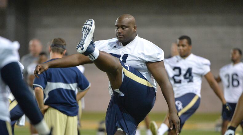 Georgia Tech offensive lineman Shamire Devine (71) and other players warm up during the first day of practice at Rose Bowl Field on Georgia Tech campus on Thursday, August 4, 2016. HYOSUB SHIN / HSHIN@AJC.COM