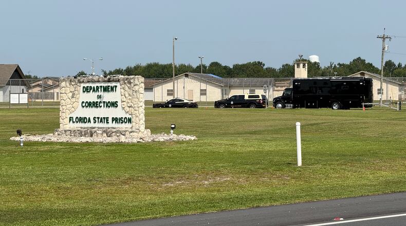 FILE - Law enforcement vehicles sit parked outside the Florida state prison in Starke, Fla., on Tuesday, July 28, 2026. (AP Photo/David Fischer, file)