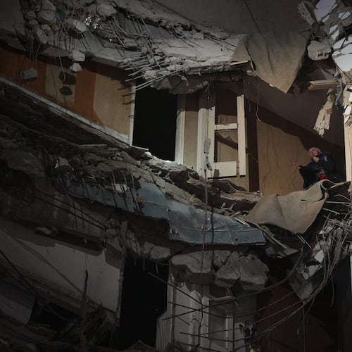 A woman stands at a destroyed apartment on a building that was hit in an Israeli airstrike in central Beirut, Lebanon, Wednesday, April 8, 2026. (AP Photo/Emilio Morenatti)