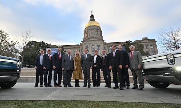 December 16, 2021 Atlanta - Governor Brian Kemp (center) and Georgia lawmakers pose with Helen Russell, Chief People Officer at Rivian, during a press conference at Liberty Plaza across from the Georgia State Capitol in Atlanta on Thursday, December 16, 2021. Electric vehicle maker Rivian on Thursday confirmed its plans to build a $5 billion assembly plant and battery factory in Georgia, which Gov. Brian Kemp called Òthe largest single economic development project ever in this stateÕs history.Ó (Hyosub Shin / Hyosub.Shin@ajc.com)