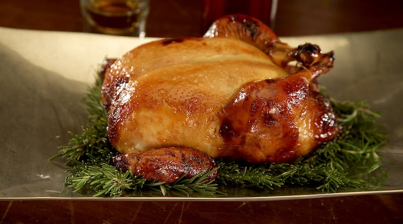 Distilled liquors such as bourbon can enhance the flavor of food, like this honey-bourbon roast chicken. (Kirk McKoy/Los Angeles Times/TNS)