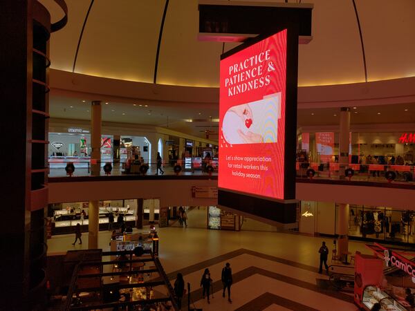 A message on a sign in Cumberland Mall's center court carries extra importance this year for stores facing a shortage of workers and delayed inventory. "Practice Patience & Kindness," the message says. "Let's show appreciation for retail workers this holiday season." MATT KEMPNER / AJC