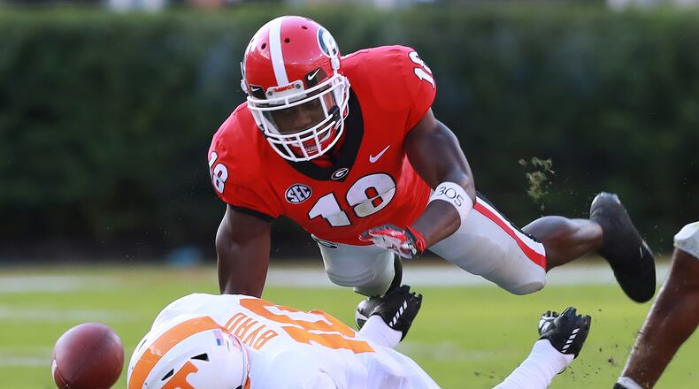 Georgia defensive back Deandre Baker breaks up a pass by leveling Tennessee wide receiver Tyler Byrd during a September game in Athens. (Curtis Compton/ccompton@ajc.com).