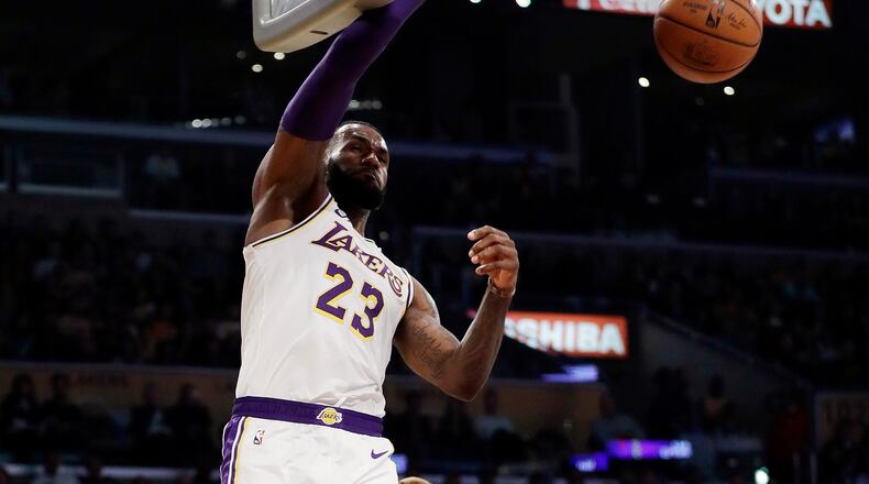 Lakers' LeBron James (23) dunks against the Atlanta Hawks on Sunday night in Los Angeles. (AP Photo/Marcio Jose Sanchez)