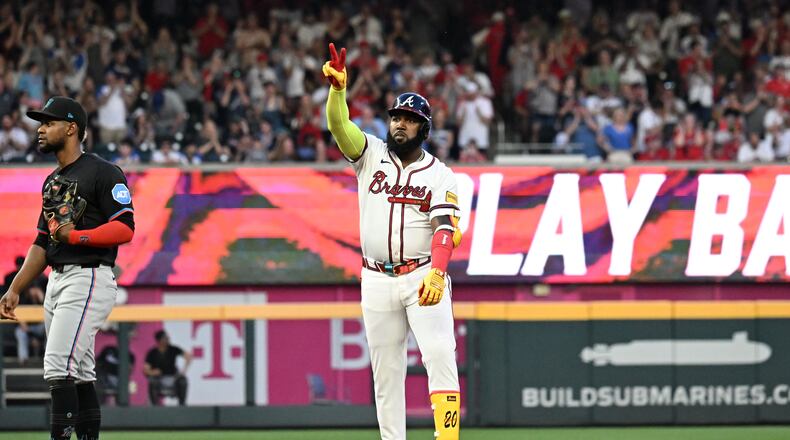 Atlanta Braves designated hitter Marcell Ozuna (20) celebrates after hitting a 2 RBI double to score Atlanta Braves second base Ozzie Albies and Atlanta Braves outfielder Michael Harris II during the third inning of home opener baseball game at Truist Park, Friday, April 4, 2025, in Atlanta. (Hyosub Shin / AJC)