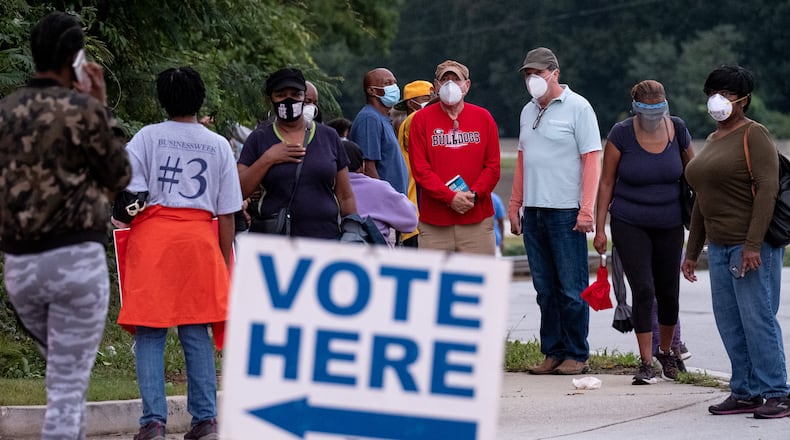 201012-Decatur-Hundreds of people waiting to vote form a line snaking out of the parking of the DeKalb County elections office in Decatur on Monday morning October 12, 2020 an hour after the polling place opened. Ben Gray for the Atlanta Journal-Constitution