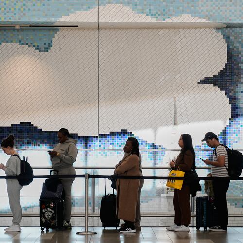 Travelers wait in a lines to get through security at LaGuardia Airport in New York, Monday, March 30, 2026. (AP Photo/Seth Wenig)