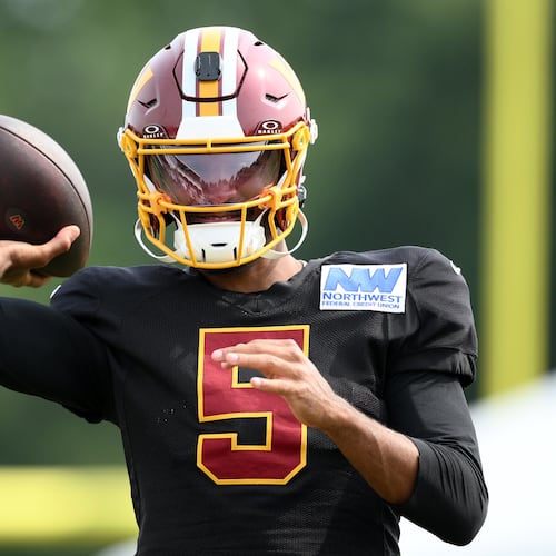 Washington Commanders quarterback Jayden Daniels works out before a joint practice with the Miami Dolphins at NFL football training camp, Wednesday, Aug. 12, 2026 in Ashburn, Va. (AP Photo/Nick Wass)