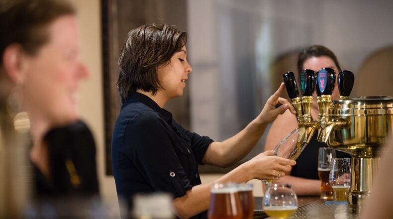 Olivia Morales, head of marketing, pours a beer for a visitor to the Abbey of the Holy Goats brewery in Roswell. Photo by Bita Honarvar/Special