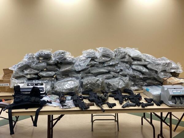 Police serving an arrest warrant on a man wanted on drug trafficking and weapons charges discovered a haul of more than 100 pounds of marijuana, cocaine and other illegal items in northeast Georgia. (Image Braselton Police) 