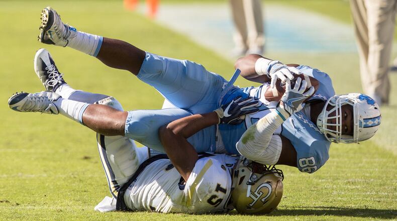 North Carolina’s Carl Tucker (86) falls on Georgia Tech’s A.J. Gray (15) after making a catch in the Tar Heels’ 48-20 win last week. (AP Photo/Ben McKeown)
