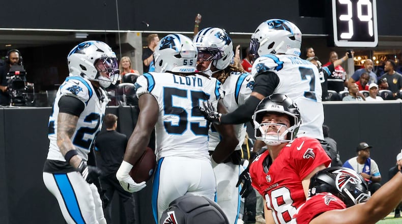 Atlanta Falcons quarterback Jack Strand (18), center, kneeling as the Carolina Panthers celebrate a touchdown after a fumble recovery during the second half of an NFL game at Mercedes-Benz Stadium in Atlanta on Sunday, Sept. 20, 2026. (Miguel Martinez/AJC)