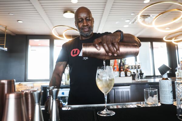 Bartender Russell Barnes pours a drink at Retreat by the Gathering Spot in Atlanta on Friday, March 6, 2026. Barnes has been bartending for The Gathering Spot since its first day. (Abbey Cutrer/AJC)