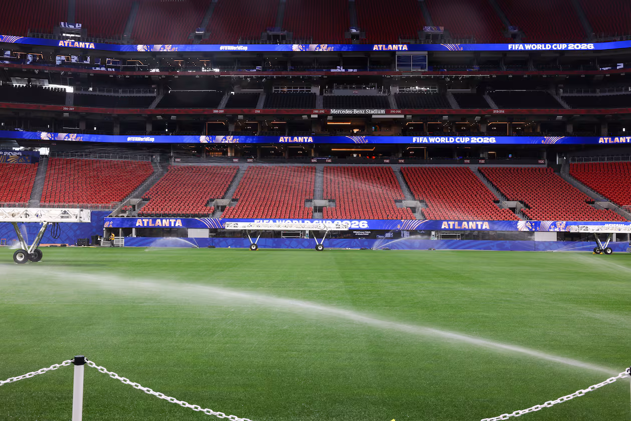 The newly installed playing surface for the FIFA World Cup is watered at the stadium in Atlanta on May 21, 2026. The pitch is Kentucky bluegrass mixed with perennial ryegrass with artificial fibers stitched in. It came from a turf farm in Colorado. (Arvin Temkar/AJC)