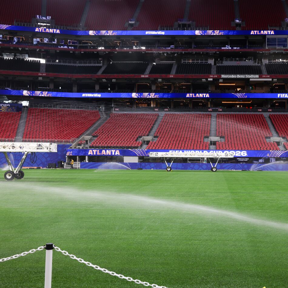 The newly installed playing surface for the FIFA World Cup is watered at the stadium in Atlanta on May 21, 2026. The pitch is Kentucky bluegrass mixed with perennial ryegrass with artificial fibers stitched in. It came from a turf farm in Colorado. (Arvin Temkar/AJC)