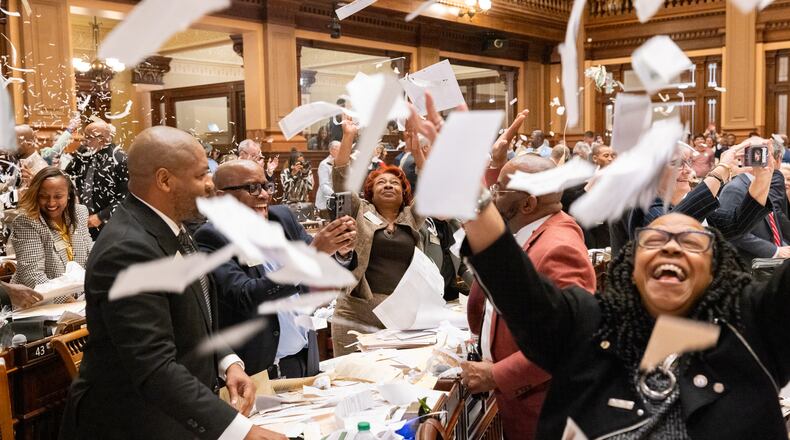 Georgia senators throw papers in the air as they adjourn the 2025 legislative session Friday night. Arvin Temkar / arvin.temkar@ajc.com