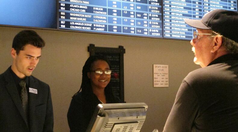 A gambler ponders the odds at a betting window at the new sports book at Bally’s casino in Atlantic City, N.J. (AP Photo/Wayne Parry)