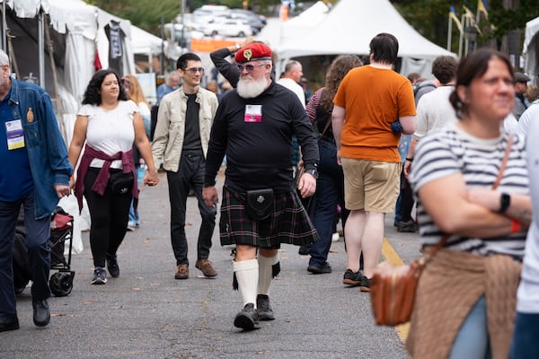 Chris Clark (center) strolls through the vendor area while attending his 30th Stone Mountain Highland Games and Scottish Festival on Sunday, Oct. 19, 2025. (Ben Gray for the AJC)