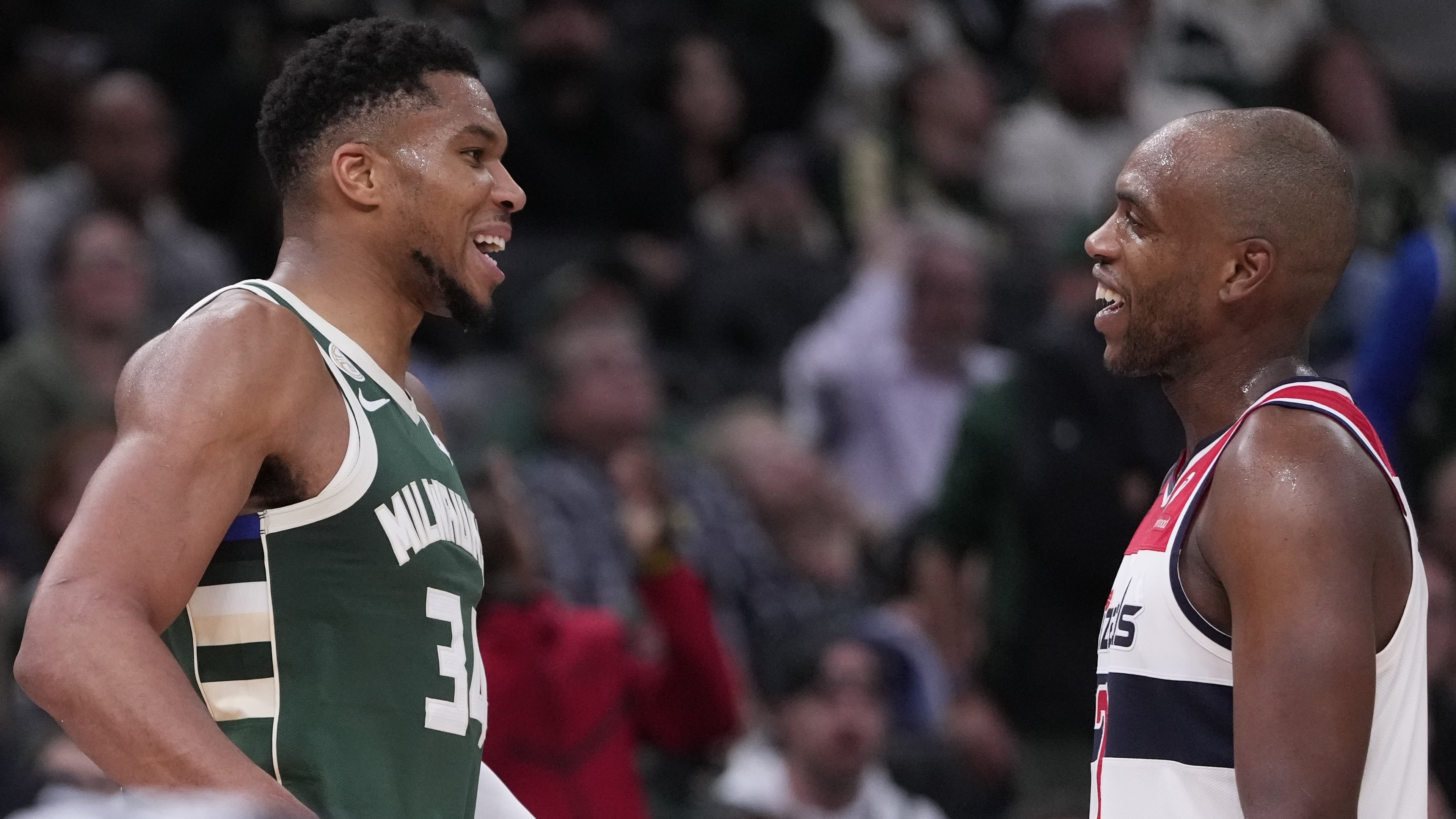 Milwaukee Bucks' Giannis Antetokounmpo and Washington Wizards' Khris Middleton share a laugh during the second half of an NBA basketball game Wednesday, Oct. 22, 2025, in Milwaukee. (AP Photo/Morry Gash)