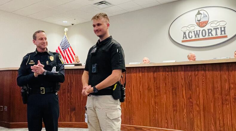 Acworth police Chief Jesse Evans (left) introduces Public Safety Liaison, Justin Reaid at a recent city council meeting.