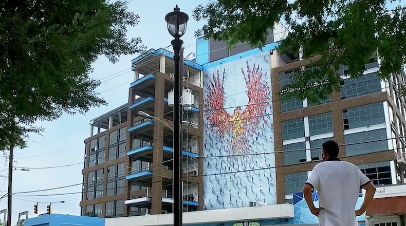 Atlanta artist Craig Alan's mural, "From the Ground Up," rises more than 90 feet over Howell Mill Road in West Midtown.
Courtesy of 8West
