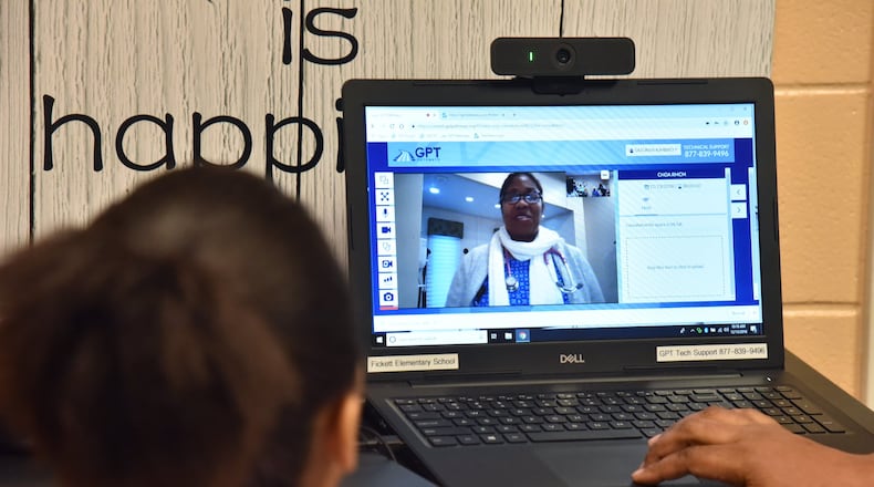 In this photo pediatric nurse practitioner Martha Cargill speaks on a computer from her clinic. (PHOTO by HYOSUB SHIN / HSHIN@AJC.COM)