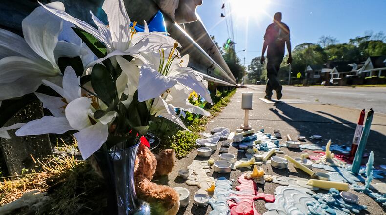 A memorial was growing Mon., April 18, 2016, at the site where three children were struck by a vehicle that jumped a curb in northwest Atlanta. JOHN SPINK / JSPINK@AJC.COM