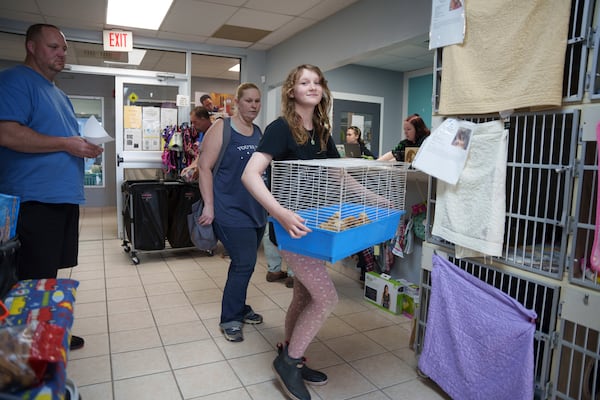 The Bruzdzinski family adopt chicks at First State Animal Center and SPCA on Friday, May 16, 2025, in Camden, Del. (AP Photo/Mingson Lau)